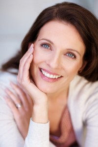 Headshot of smiling woman leaning on her hand