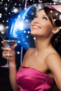 Young beautiful woman at a party wearing a cocktail dress and holding a martini glass