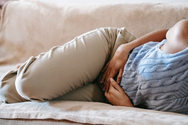 a woman experiencing stomach pain