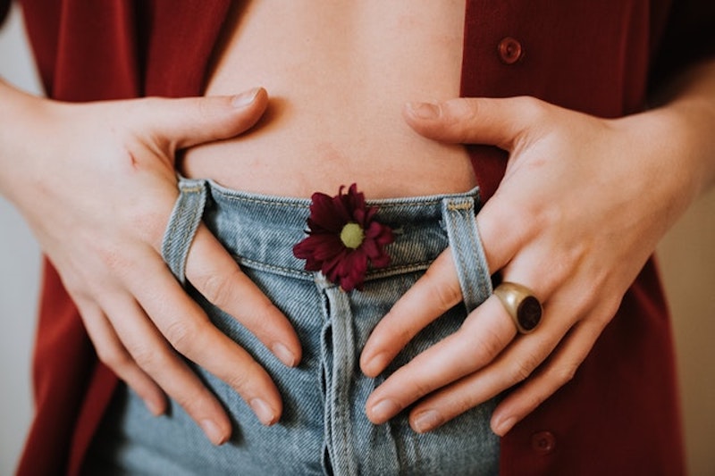 a woman holding belt loops