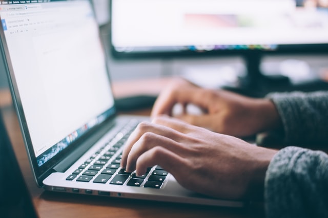 A person typing on their laptop researching their upcoming procedure.