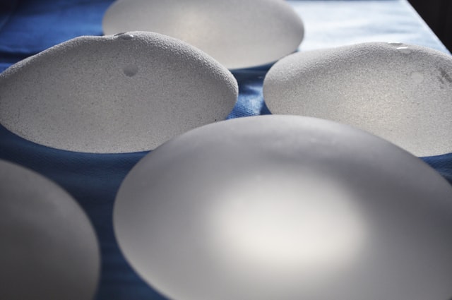 Breast implants laid out on a blue sheet
