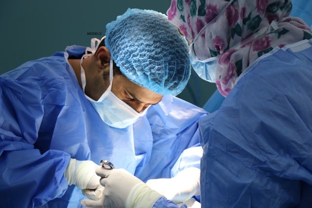 Two surgeons in an OR doing a surgery