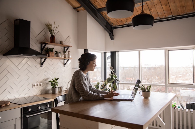 A woman working from her kitchen island