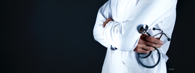 A faceless doctor holding a stethoscope in his hand.