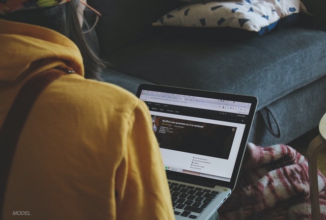 A girl using a laptop.