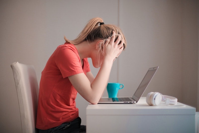 a woman sitting and looking stressed