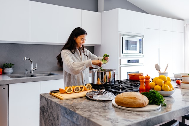 Woman preparing a healthy meal in her large and modern kitchen