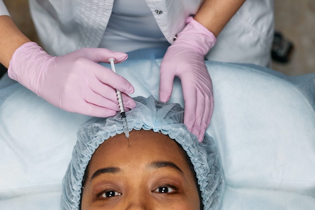 A woman getting a forehead botox