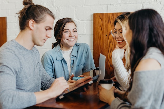 Four friends sitting at a coffee shop and talking