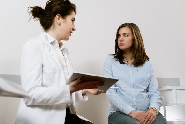 A patient consulting with her doctor about her procedure.