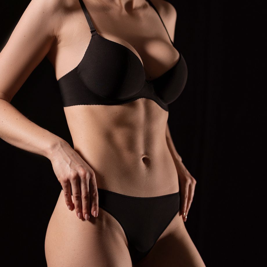woman with a black bra and toned abs