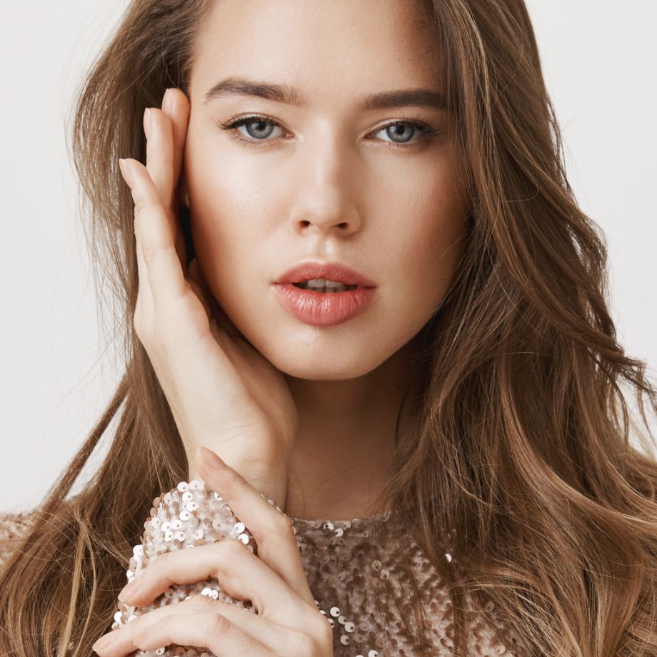 young woman touching her face